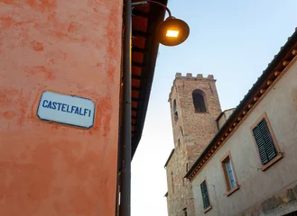 Castelfalfi street sign with medieval tower in tuscany, italy