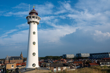 Lighthouse in the Dutch town of Egmond aan Zee with a view of the town