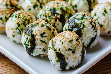 Rice balls topped with seaweed and sesame
