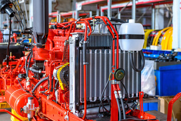 New tractor or combine harvester in soft focus on the assembly line of a tractor factory. Manufacturing of agricultural machinery at an industrial factory.