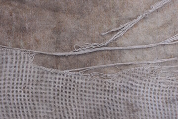 fabric texture from a piece of old dirty carpet with torn threads