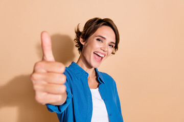 Photo portrait of pretty young girl show cheerful thumb up good quality dressed stylish blue outfit...