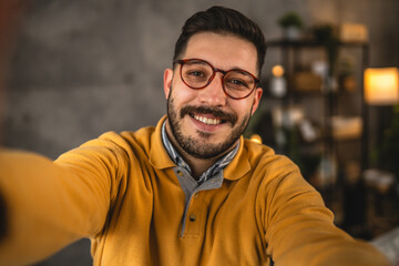 self portrait of handsome adult man with eyeglasses smile at home