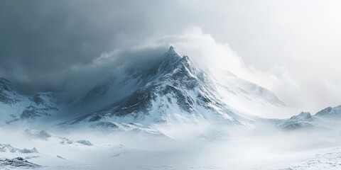 Obraz premium Snow covered mountain draped in eerie mist and wind, showcasing the majestic beauty of a snow covered mountain landscape shrouded in mystique and atmospheric conditions.