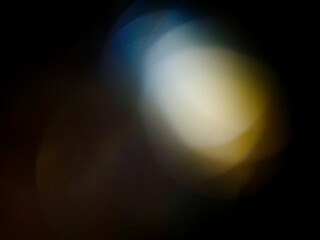 Abstract light leak effect on dark background for creating special effects. The colors are vibrant and the circles are overlapping, creating a sense of movement and energy. Abstract art.