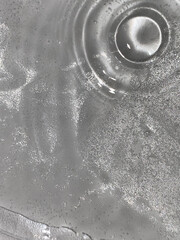 Close-up of abstract water surface with ripples and bubbles