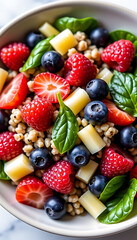 Obraz premium Fruity Quinoa Salad - A light salad made with quinoa mixed berries and a citrus dressing. background copyspace