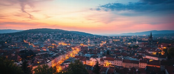 Obraz premium Aerial twilight view of urban cityscape with captivating evening sky and city lights