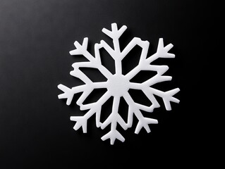 A white snowflake on a black surface