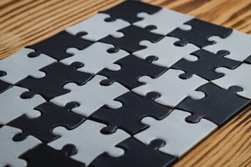 Black and white puzzle, teamwork challenge concept
