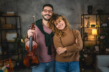 Portrait of boyfriend and girlfriend with violin at home © Miljan Živković