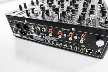 Close-Up View of Professional Audio Mixer Back Panel Connections with Inputs and Outputs