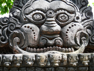 Stone carving of a face with a mouth and a nose