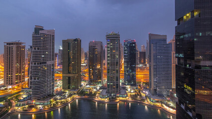 Naklejka premium Residential and office buildings in Jumeirah lake towers district night to day timelapse in Dubai