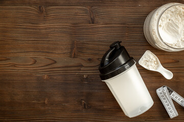 Protein shaker for sports nutrition. Whey protein powder in a scoop, top view