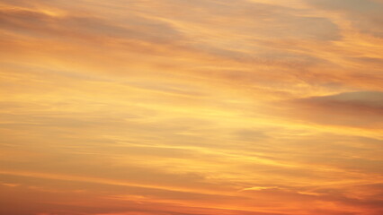 Warm orange sky at sunrise, creating a soft and dreamy background. Perfect for nature, morning, and atmospheric themes