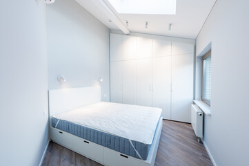 Modern Minimalist Luxury Home Bedroom Interior with White Wardrobe and Natural Light