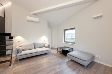 Cozy Modern Home Living Room Interior with Large Windows and Comfortable Furniture. AC on the wall