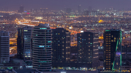 Obraz premium Dubai's business bay towers at evening aerial day to night timelapse.