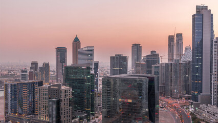 Obraz premium Dubai's business bay towers at evening aerial day to night timelapse.