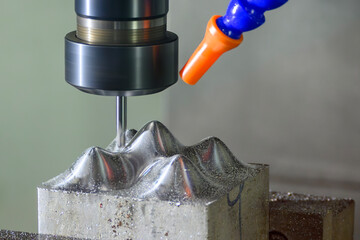 The CNC milling machine cutting  mold part by solid ball end mill tool. © Pixel_B