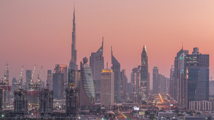 Naklejka premium Dubai skyline after sunset with beautiful city center lights and Sheikh Zayed road traffic timelapse, Dubai, United Arab Emirates