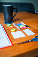 Creative Desk Setup Featuring Writing Tools, Markers, and Coffee Mug in a Cozy Environment