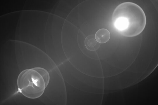 Abstract Black and White Lens Flare with Concentric Light Circles and Optical Reflections Creating a Symmetric Cosmic and Ethereal Visual Effect - Powered by Adobe