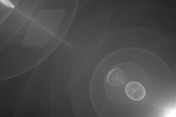 Abstract Black and White Lens Flare with Concentric Light Circles and Optical Reflections Creating a Symmetric Cosmic and Ethereal Visual Effect