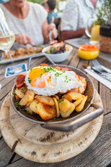 Rustic Dining with Crispy Breakfast Potatoes, Fried Egg, and Fresh Salad