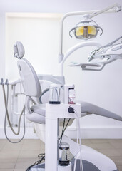Modern dental office featuring an Air Flow system for teeth cleaning, ergonomic chair, and advanced equipment in a clean clinical workspace