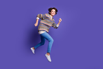 Photo of cheerful lovely adorable woman wear trendy clothes run fast hurry store mall isolated on purple color background