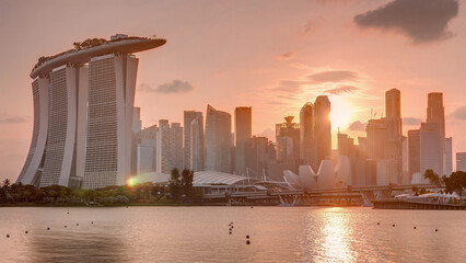 Sunset over the downtown skyline of Singapore as viewed from across the water from The Garden East...