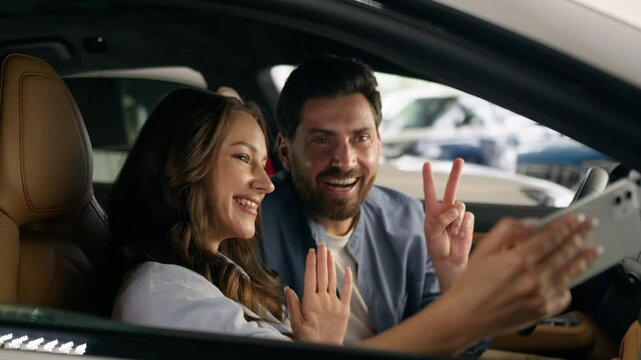 Happy Caucasian couple make selfie photo picture mobile phone video call conference blog influencer thumb up smiling in auto woman girl female with man guy male in car automobile auto social media