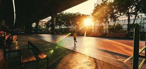child running on sports court in the city