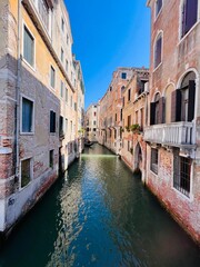 Scenic canal view between historic buildings in Venice Italy