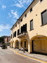 Charming street view of historical European architecture under blue sky. Padua, Italy.