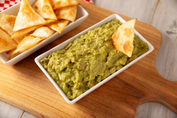 Guacamole. Avocado dip sauce, one of its many ways of consuming it is spread on tortilla chips also called Nachos. Mexican easy homemade sauce recipe very popular.