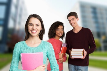 Happy young student friends in university corridor