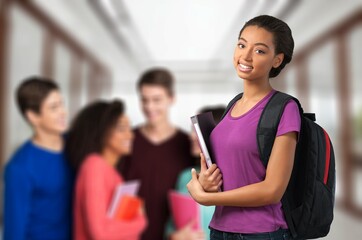 Happy young student friends in university corridor