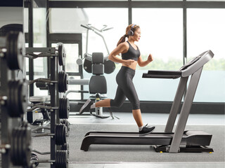 Fototapeta premium Asian woman running on a treadmill