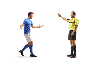 Obraz premium Referee showing a yellow card to a football player