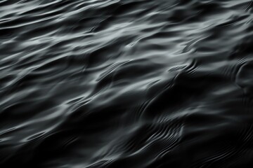 A serene black water surface with gentle ripples, creating a calming and abstract visual perfect for a contemplative mood.