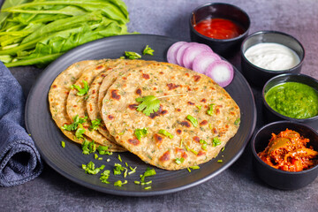 Palak paratha is a soft, spinach-filled flatbread, served with creamy, spiced palak paneer—a flavourful spinach and cottage cheese curry.