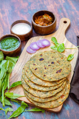 Palak paratha is a soft, spinach-filled flatbread, served with creamy, spiced palak paneer—a flavourful spinach and cottage cheese curry.