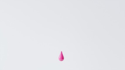 Fototapeta premium A single pink droplet suspended in mid-air against a plain white background