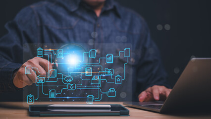 A man is using a laptop to touching a network diagram. Concept of technology and connectivity, as well as the importance of understanding and managing complex systems