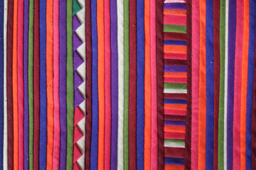 The colorful fabric pattern is arranged alternately in a vertical line, beautifully and clearly. The abstract background is unique.