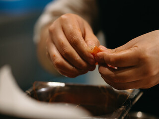 close up of hands preparing prawn