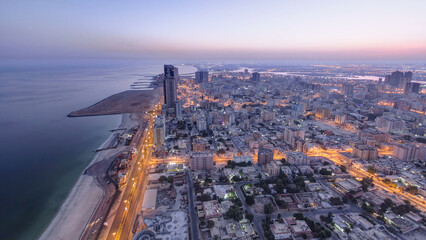 Cityscape of Ajman from rooftop night to day timelapse. Ajman is the capital of the emirate of Ajman in the United Arab Emirates.